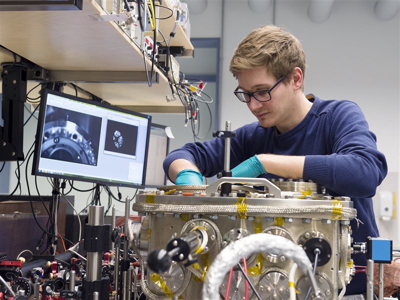 picture of a scientist working on a vacuum chamber